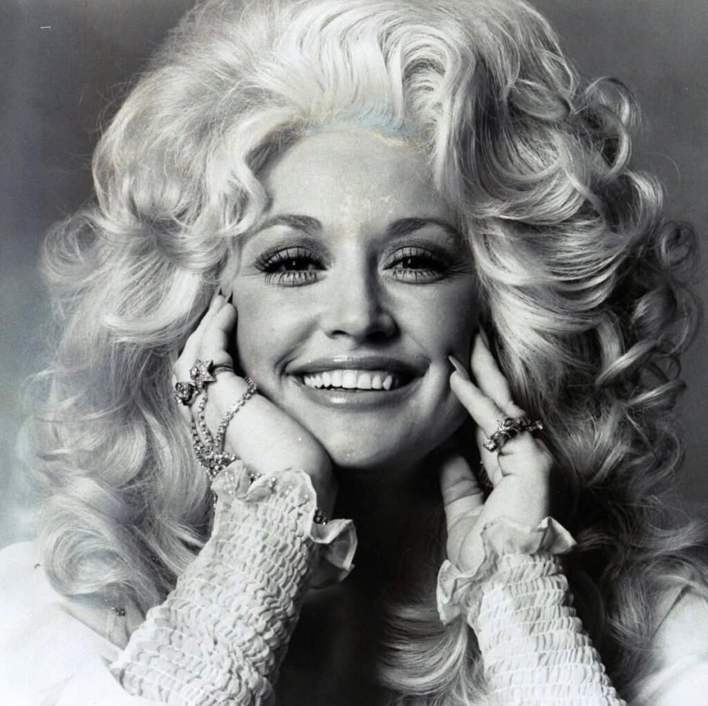 Black-and-white fine art portrait of Dolly Parton with dramatic contrast